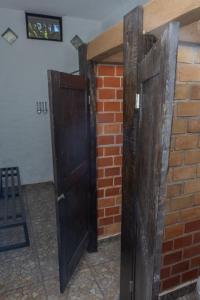 two sets of doors on a brick wall at Hostal Maria Tepozteca in Tepoztlán