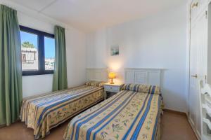 Apartamentos Flamingo客房内的一张或多张床位