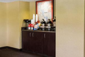 a room with a counter with bottles and condiments on it at Red Roof Inn PLUS+ Wilmington - Newark in Christiana