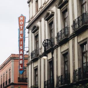 a hotel sign on the side of a building at Hotel Isabel in Mexico City