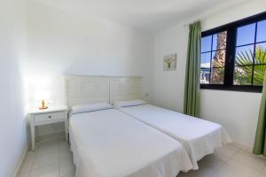 Apartamentos Flamingo客房内的一张或多张床位