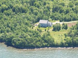 an aerial view of a house on an island in the water at Tulloch Inn & Gifts in Inverness