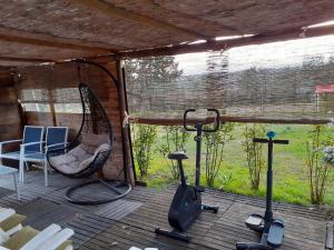 a screened in porch with a chair and a swing at Il Lavandeto - farmhouse in the city in Siena