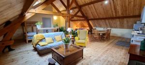 a living room with a couch and a table at Loft mansardé du train jaune avec vue sur les montagnes in Saillagouse