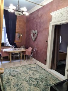 a dining room with a table and a heart wall at Marabeth Guest House in Zagreb