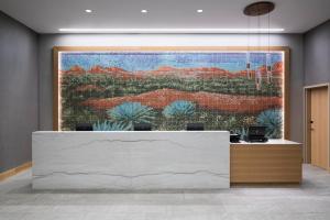 a lobby with a large painting on the wall at Hyatt House Tempe Phoenix University in Tempe