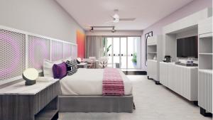 a bedroom with a large bed and a kitchen at Almar Resort Luxury LGBT Beach Front Experience in Puerto Vallarta