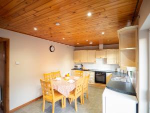 a kitchen with a table and chairs in a kitchen at Sea view cottage in Tully Cross