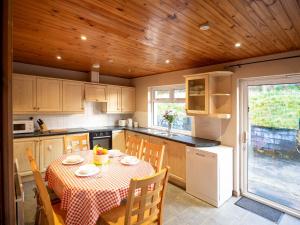 a kitchen with a table and chairs with a table and a table and a kitchen at Sea view cottage in Tully Cross