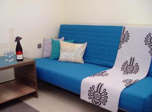 a blue couch with pillows on it in a room at Apartamenty Jagiellonka in Zakopane