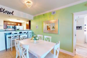 a kitchen and dining room with a white table and chairs at Waterscape A VIII in Fort Walton Beach