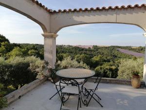 un tavolo e sedie su un patio con vista di Gîtes Lou Limbert Plateau de Valensole a Valensole