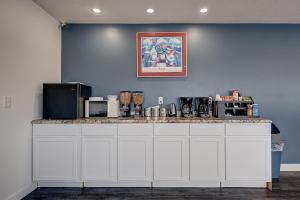 a kitchen with a counter top with appliances on it at Travelodge by Wyndham Spirit Lake/Okoboji in Spirit Lake