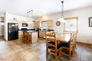 a kitchen and dining room with a table and chairs at Take a break in South Fork