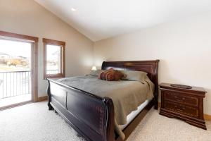 a bedroom with a bed and a dresser and a window at Take a break in South Fork