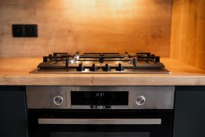 a stove top oven sitting inside of a kitchen at Skylark - Manhattan Penthouse with Jacuzzi & Panoramic View in Braşov