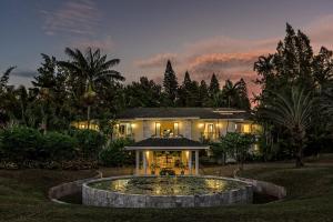 a house with a large fountain in front of it at Hawaii Island Retreat at Ahu Pohaku Ho`omaluhia in Kapaau