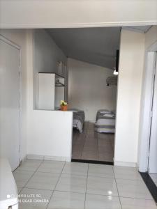 a living room with two beds in a room at Pousada das Letras in São Thomé das Letras