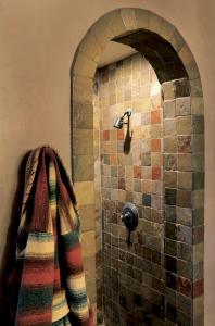 a shower in a bathroom with a tiled wall at El Portal Sedona Hotel in Sedona