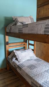 two bunk beds sitting on top of a room at Hostel Sauce in Mar del Plata
