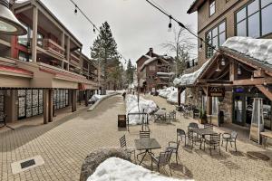 a snowy street with chairs and tables and buildings at 2 Mi to Northstar Resort Idyllic Cabin with Shuttle in Truckee