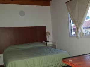 a bedroom with a bed and a window at Cabañas Villa del Sol in Salta +26 photos