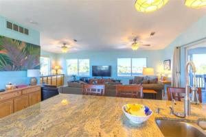 a kitchen and living room with a counter top at Endless Summer, North Captiva Island in North Captiva
