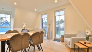 a living room with a table and chairs and a couch at Strandhaus Zingst Apartment 15 in Zingst