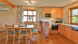 a kitchen with a table and chairs in a room at Heideröschen Park Heideröschen 9a in Zingst