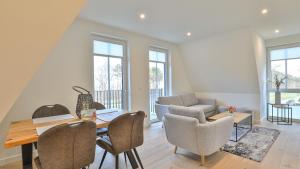 a living room with a table and chairs at Strandhaus Zingst Apartment 14 in Zingst