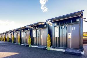 a row of portable toilets in a parking lot at HOTEL R9 The Yard Yaita in Yaita