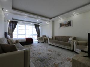 een grote woonkamer met banken en een bed bij CNR OTEL Airport in Istanbul