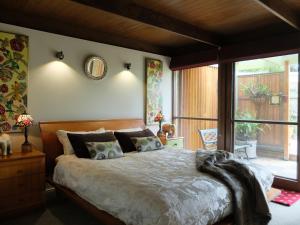 a bedroom with a large bed and a large window at Braeside Bliss in Sherbrooke