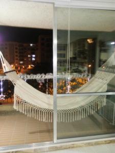 a hammock hanging from the window of a building at PeñalisaKapoSalSar in Girardot