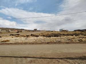 an empty road in the middle of a field at Apart Estepa in El Calafate
