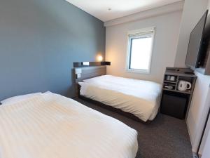 Postel nebo postele na pokoji v ubytování Super Hotel Ishikawa Nomineagari Smart Inter
