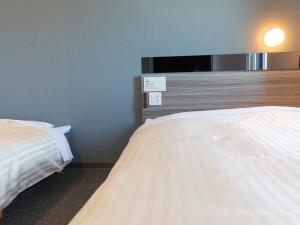 Postel nebo postele na pokoji v ubytování Super Hotel Ishikawa Nomineagari Smart Inter