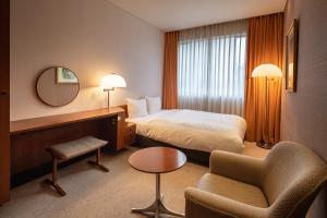 Ένα ή περισσότερα κρεβάτια σε δωμάτιο στο Chigusa Hotel