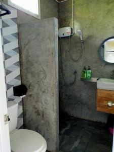 a bathroom with a shower with a toilet and a sink at Smile Box Coffee & Resort in Ban Nong Hin