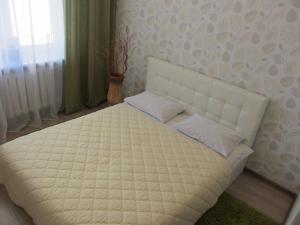 a bed in a bedroom with a white mattress at PaulMarie Apartments on Mayakovskogo 24 in Brest