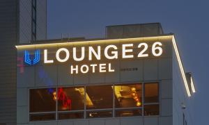 a large neon sign on top of a hotel at Busan Lounge 26 Hotel in Busan