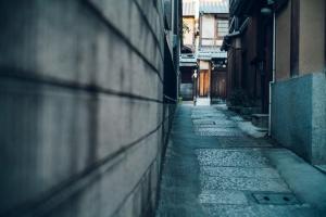 an empty alley with a stone path between two buildings at Nozomu House Kyoto in Kyoto