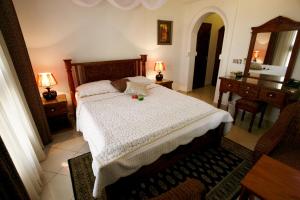 Rúm í herbergi á Al-Minar Hotel