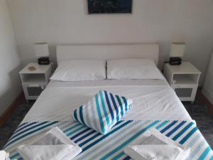 a bedroom with a bed with two night stands at apartman-maja-krk in Krk
