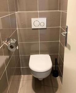 a bathroom with a toilet with two rings on the wall at Les Sarments in Le Lavandou