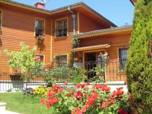 a wooden house with flowers in front of it at Turquhouse Hotel in Istanbul