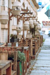 a row of wooden benches sitting on top of a sidewalk at Hotel Merseburger Hof in Leipzig