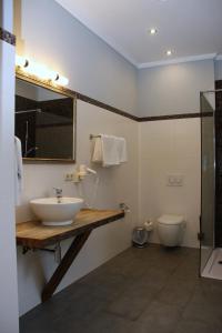 a bathroom with a sink and a toilet at Hotel Zeil in Frankfurt/Main