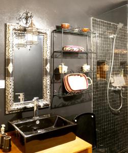 bagno con lavandino, specchio e doccia di Riad Bobby Marrakech a Marrakech