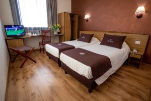 Postel nebo postele na pokoji v ubytování Tulip Inn Padova